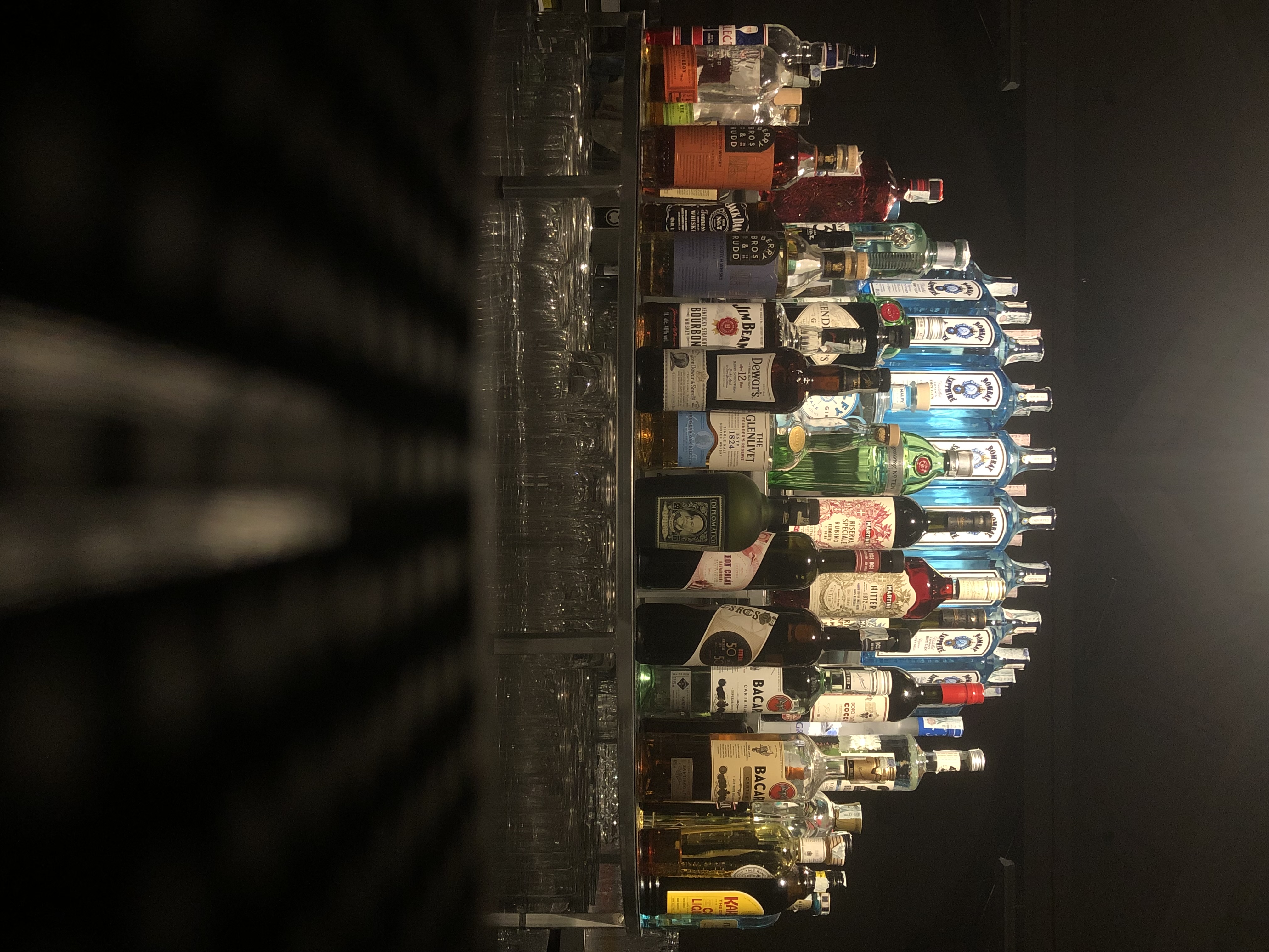 Backlit spirits collection on a bar shelf